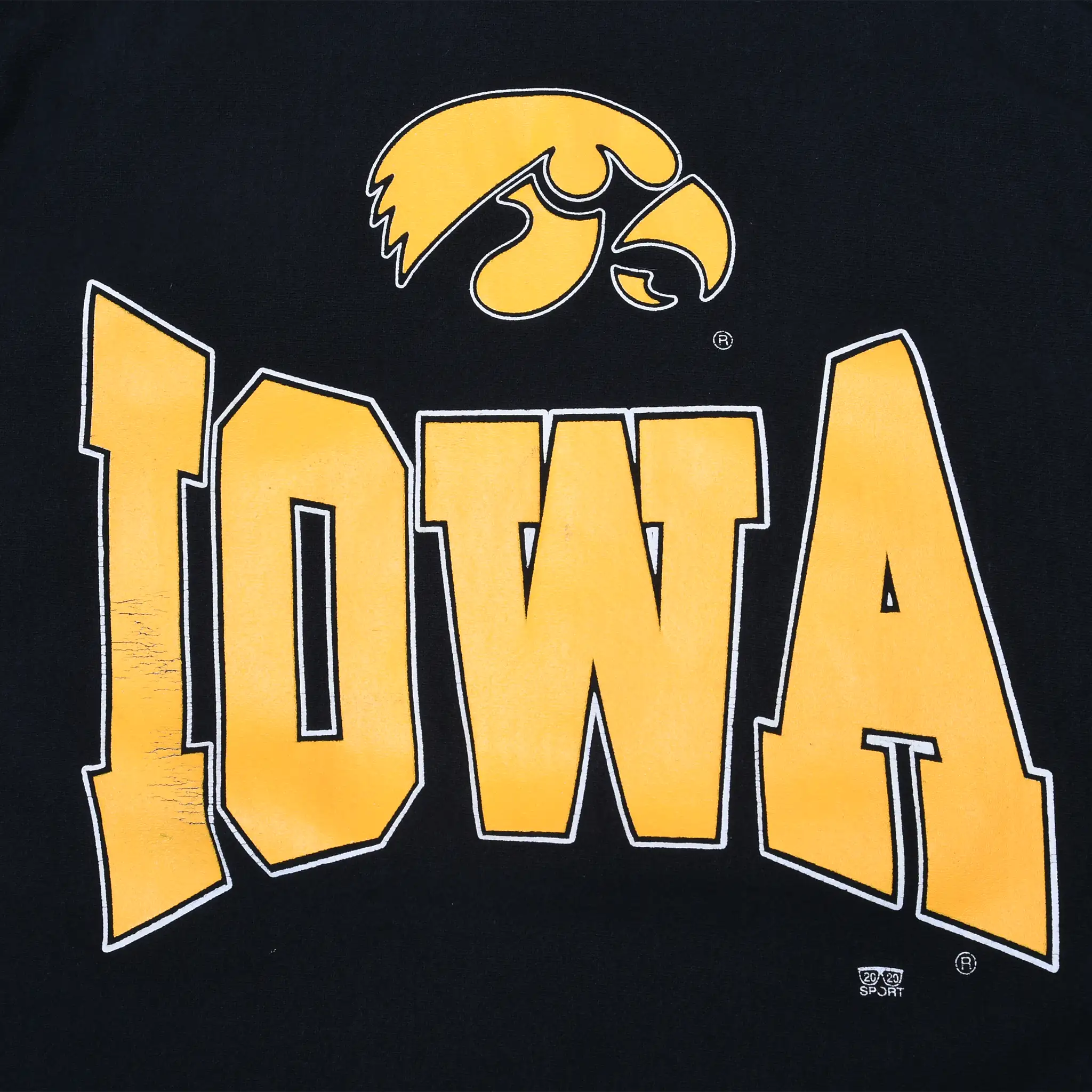 Close-up of gold Iowa wordmark and Hawkeyes logo printed on black sweatshirt