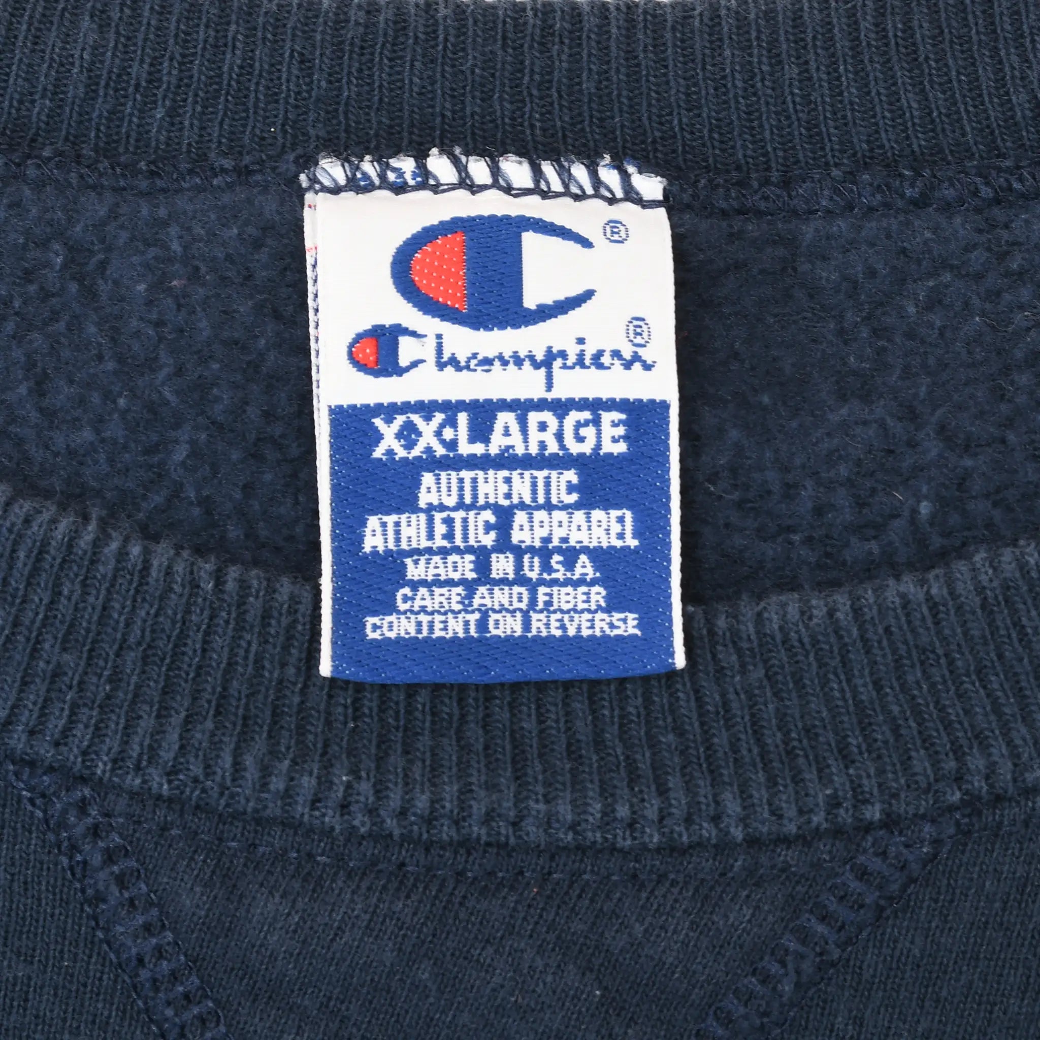 Champion XX-Large neck tag inside navy blue sweatshirt