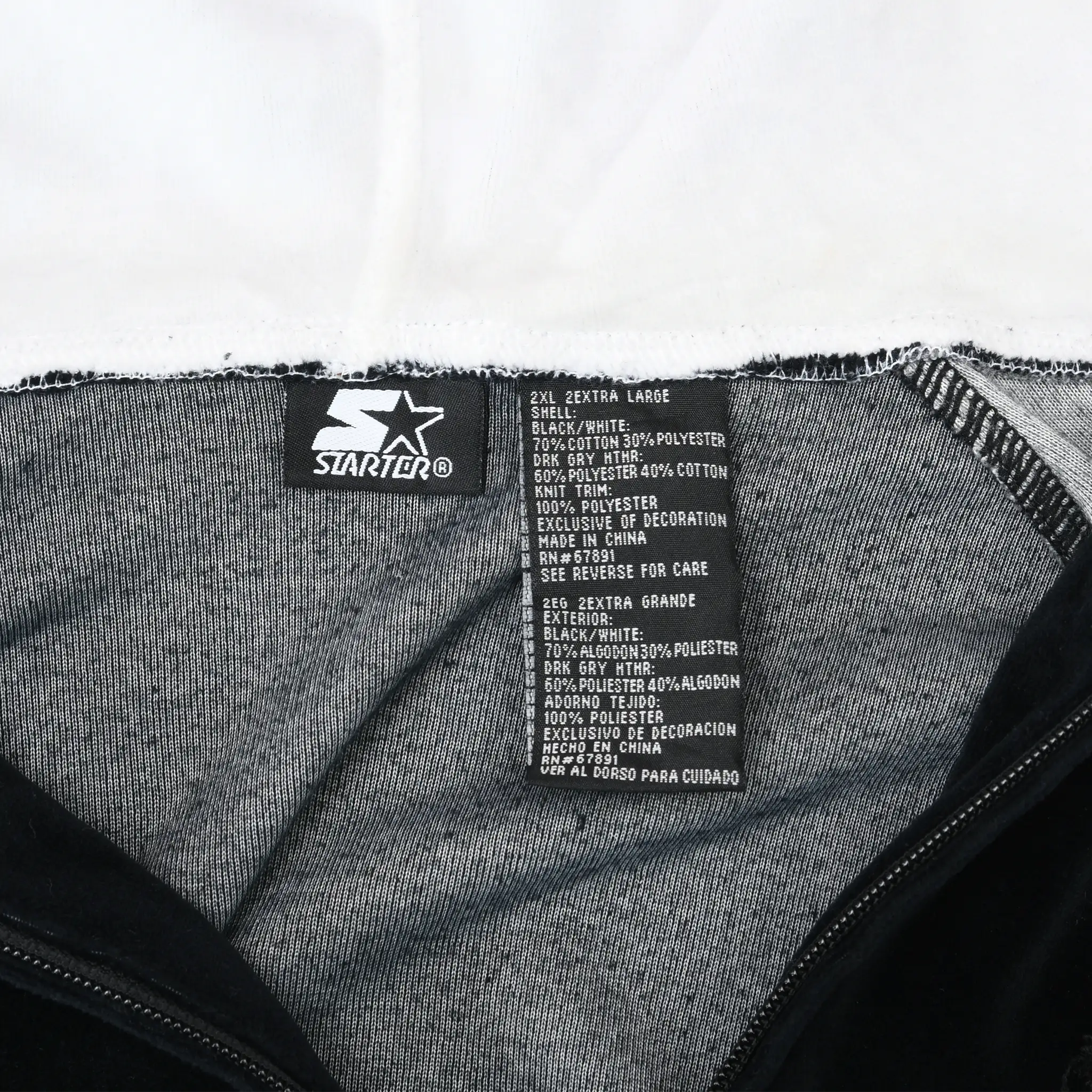 Starter neck and care labels inside black hoodie marked 2X extra large