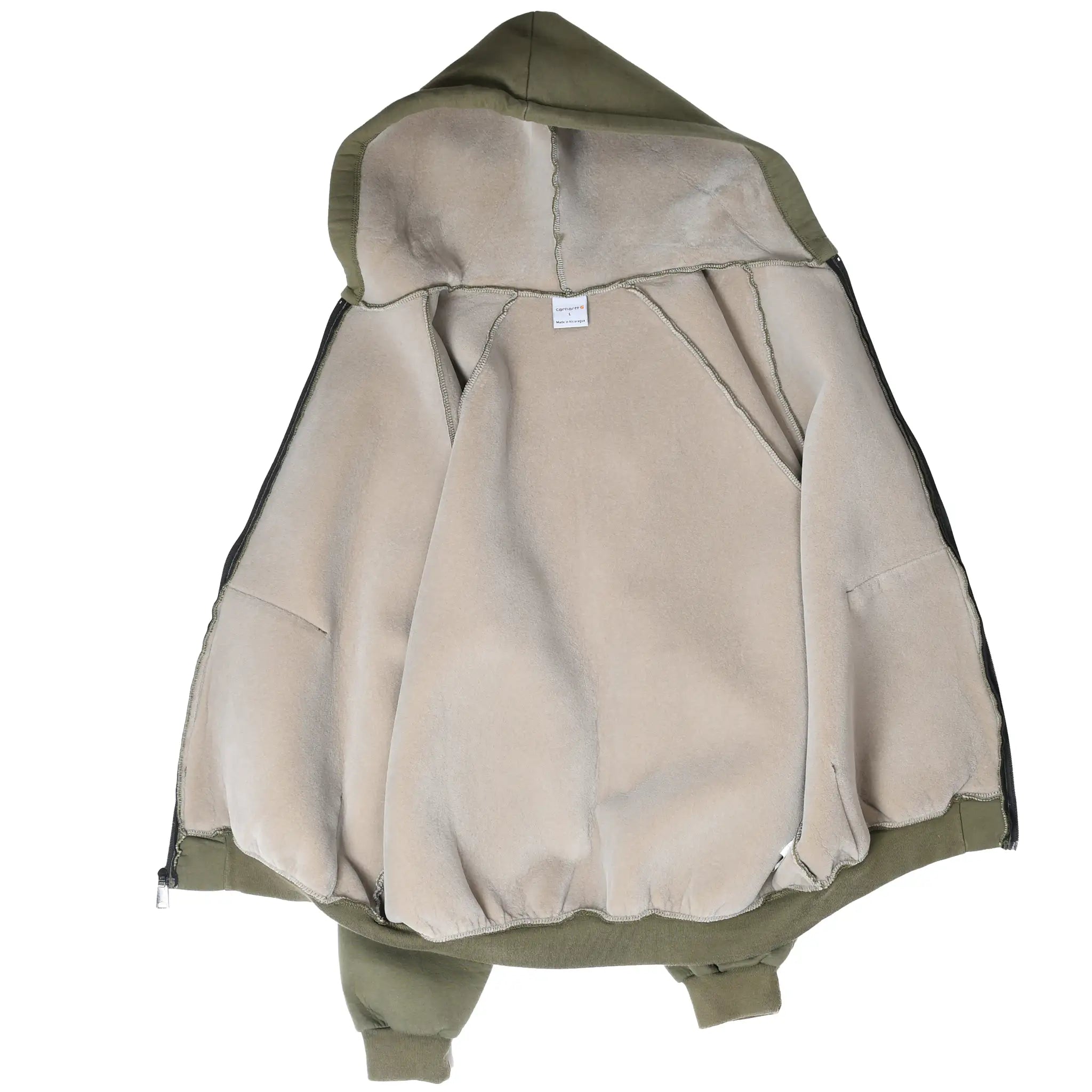 Inside view of olive green Carhartt hoodie showing beige fleece lining and exposed seams
