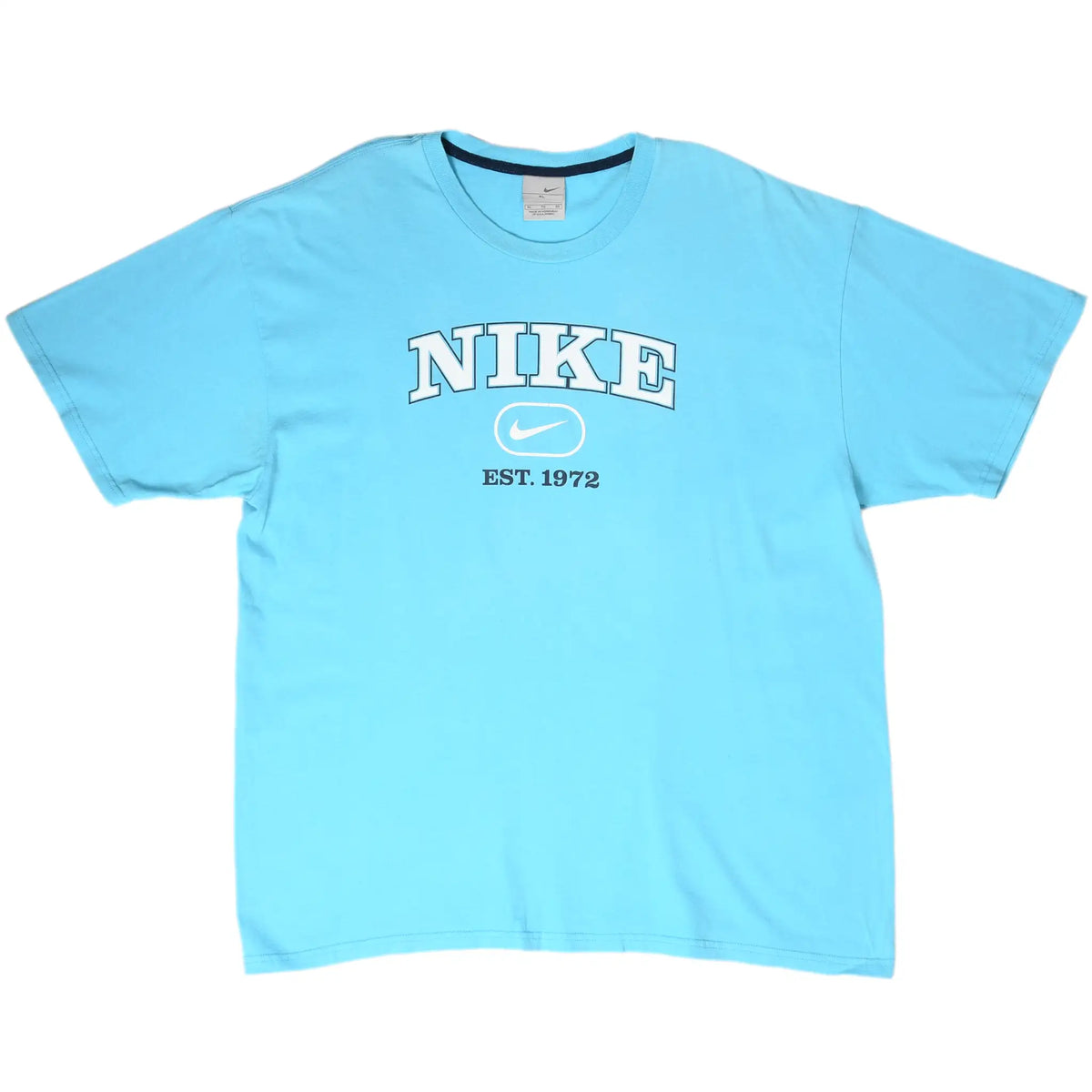 Front of light blue Nike T-shirt with white spellout, Swoosh, and Est. 1972 chest graphic