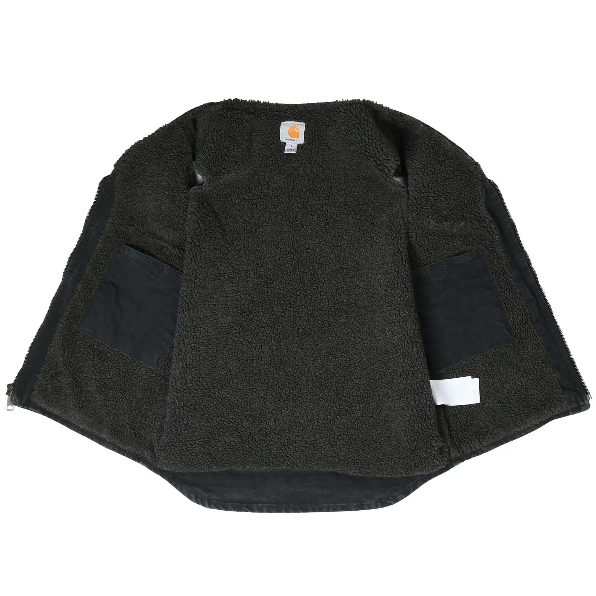 Open Carhartt vest showing black sherpa lining and interior pockets