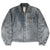 Full front of faded gray Carhartt Detroit jacket with three pockets and logo patch