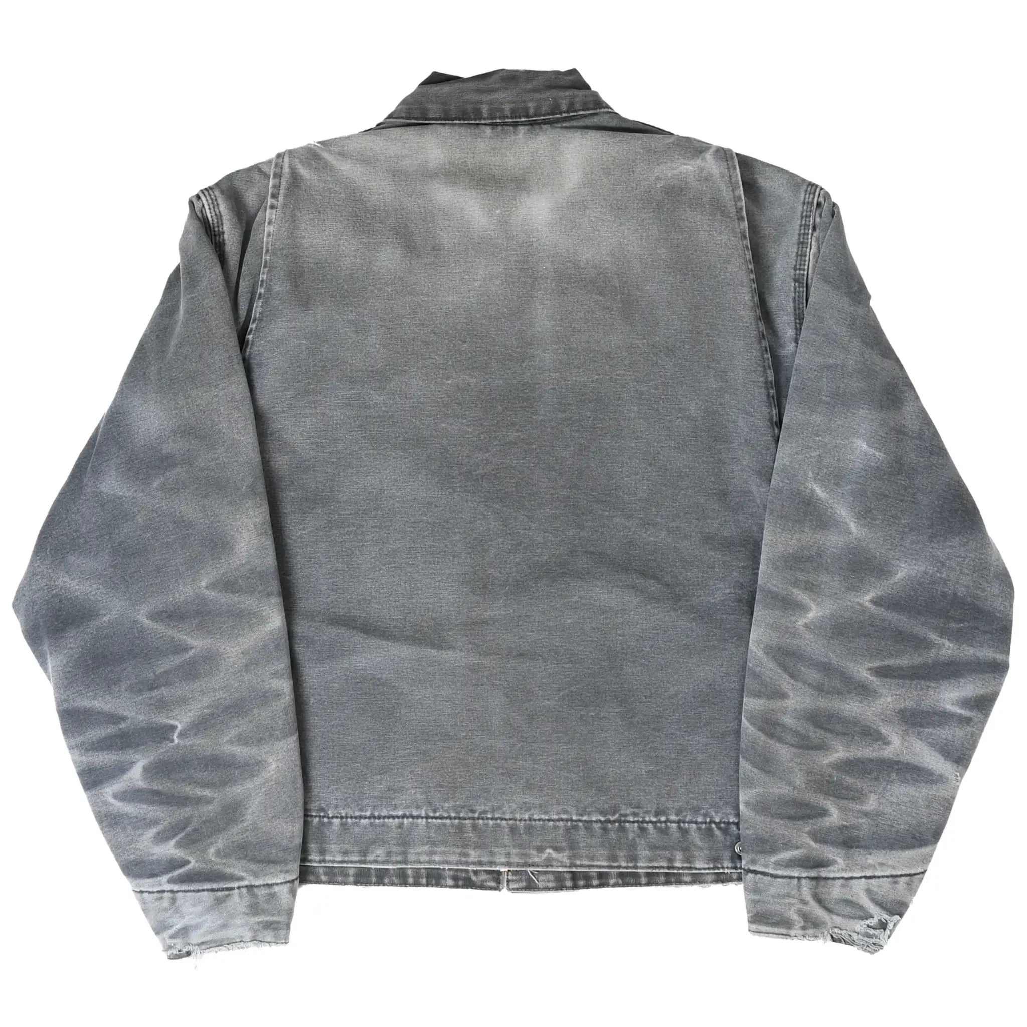 Back of faded gray Carhartt Detroit jacket with pronounced sleeve whiskering