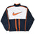 Back of Nike windbreaker with large orange Swoosh and orange stripes on navy and white panels