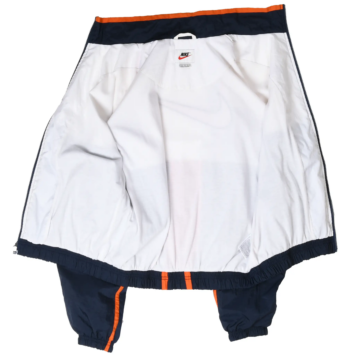 Inside view of Nike windbreaker showing white lining, neck label and navy elastic hem