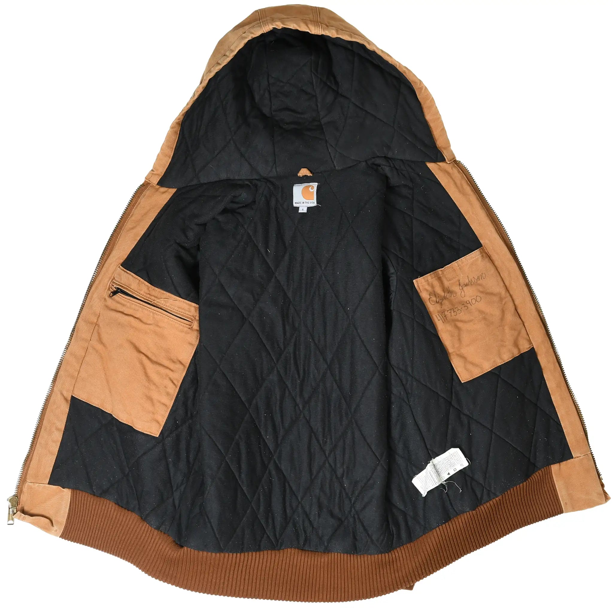 Open Carhartt hooded jacket showing black quilted lining and interior pockets