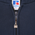 Close-up of Russell Athletic logo zipper pull and neck label on navy hoodie