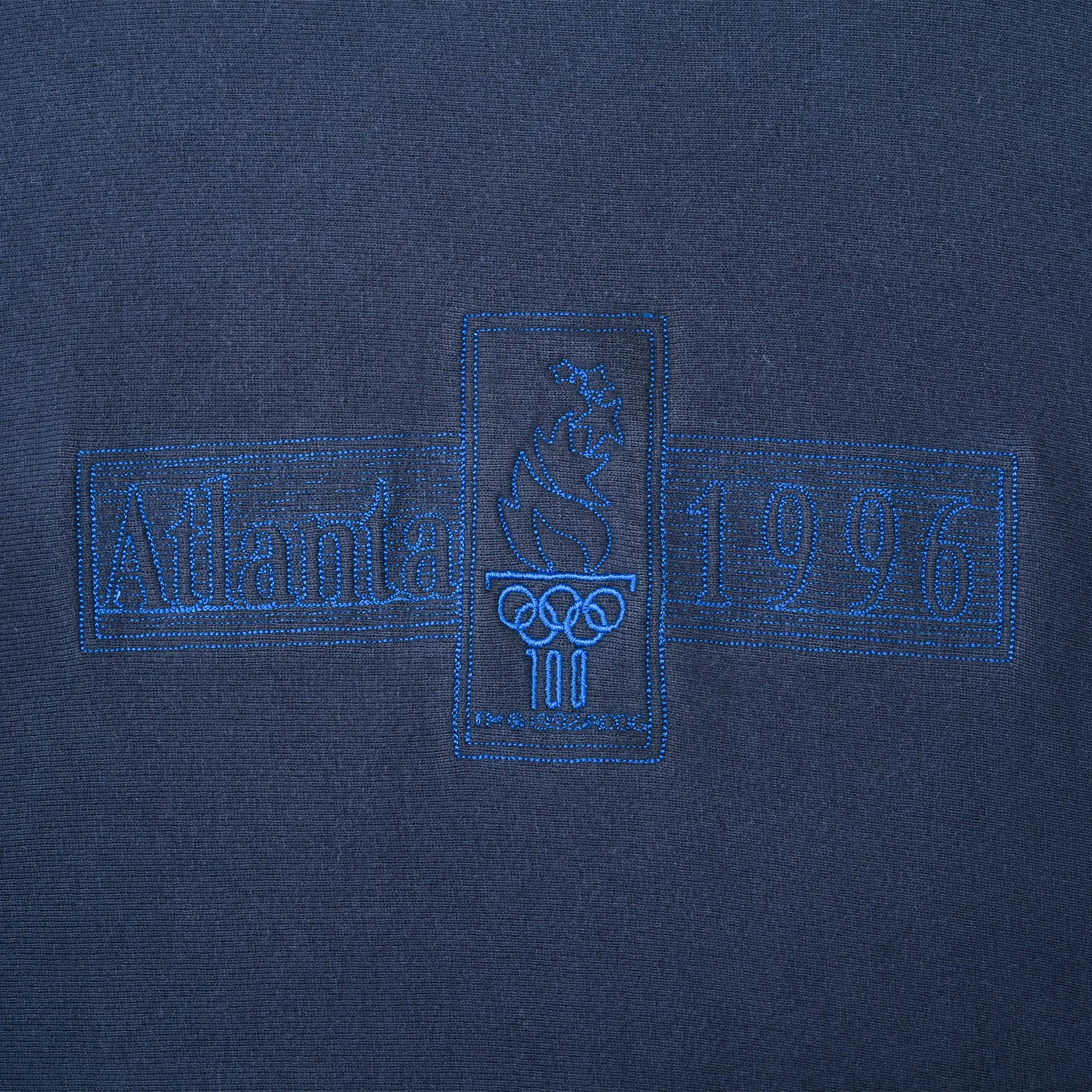 Close-up of tonal blue Atlanta 1996 Olympic Games chest embroidery