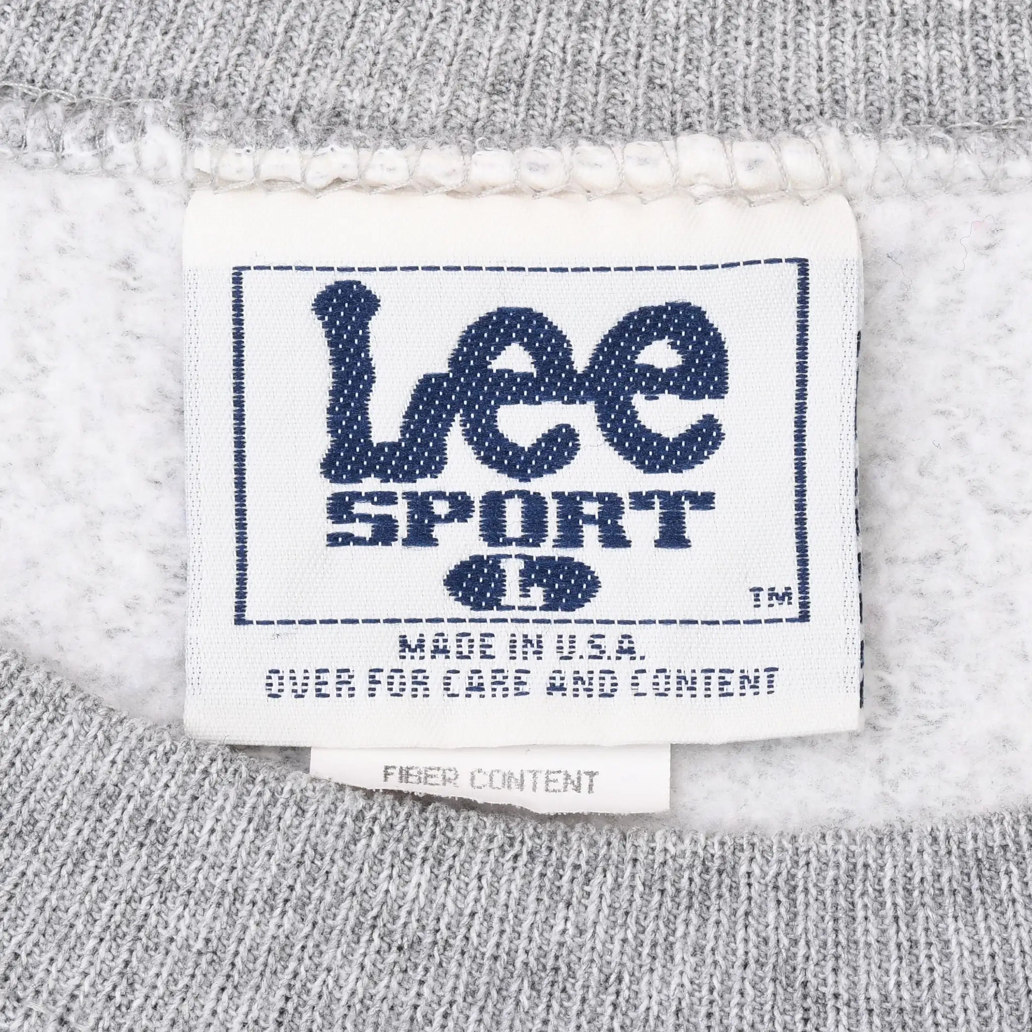 Close-up of Lee Sport neck label marked Made in USA on gray sweatshirt