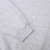 Close-up of grey sleeve cuff and small marked spots on the fabric
