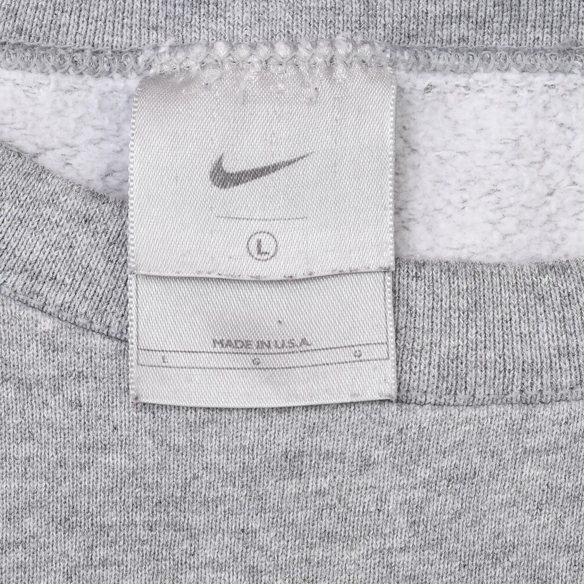 Close-up of Nike neck tag marked size large and Made in USA