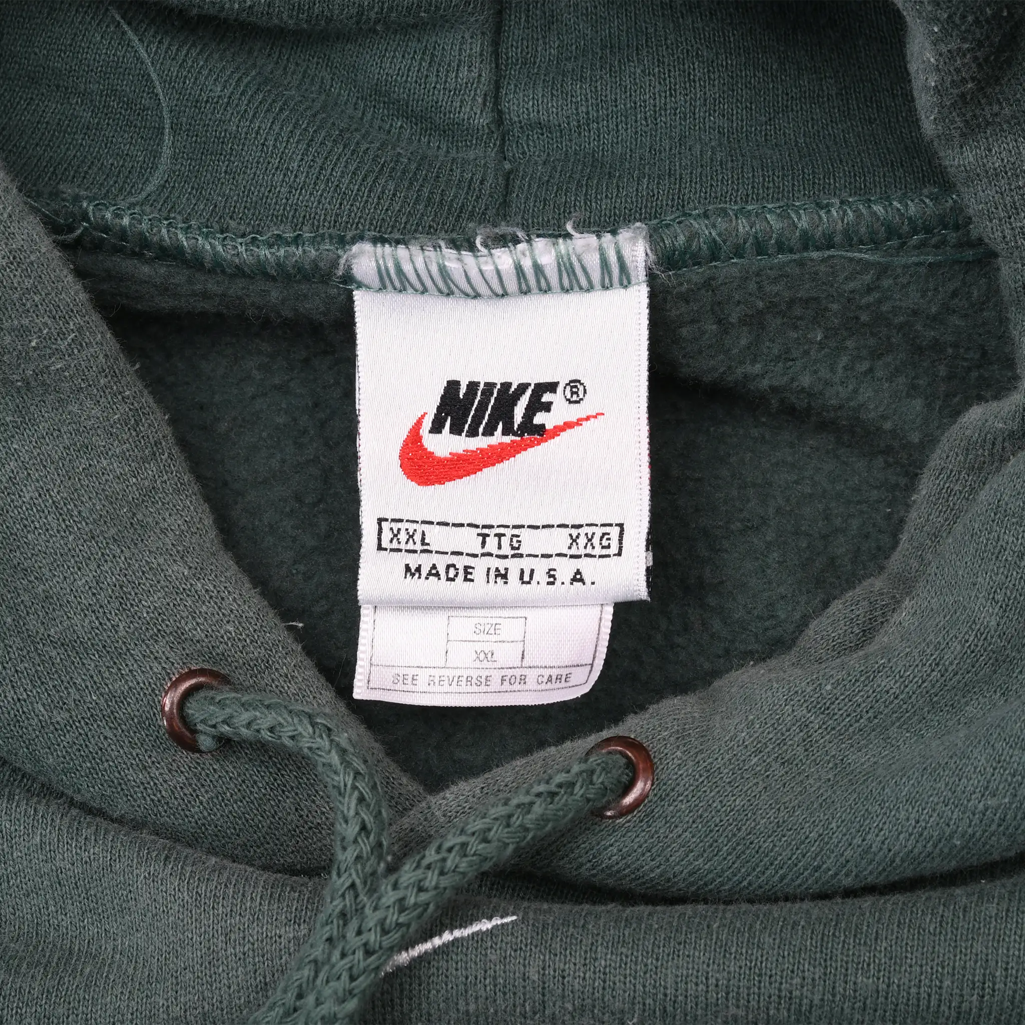 Nike neck label on green hoodie showing XXL sizing and Made in U.S.A.