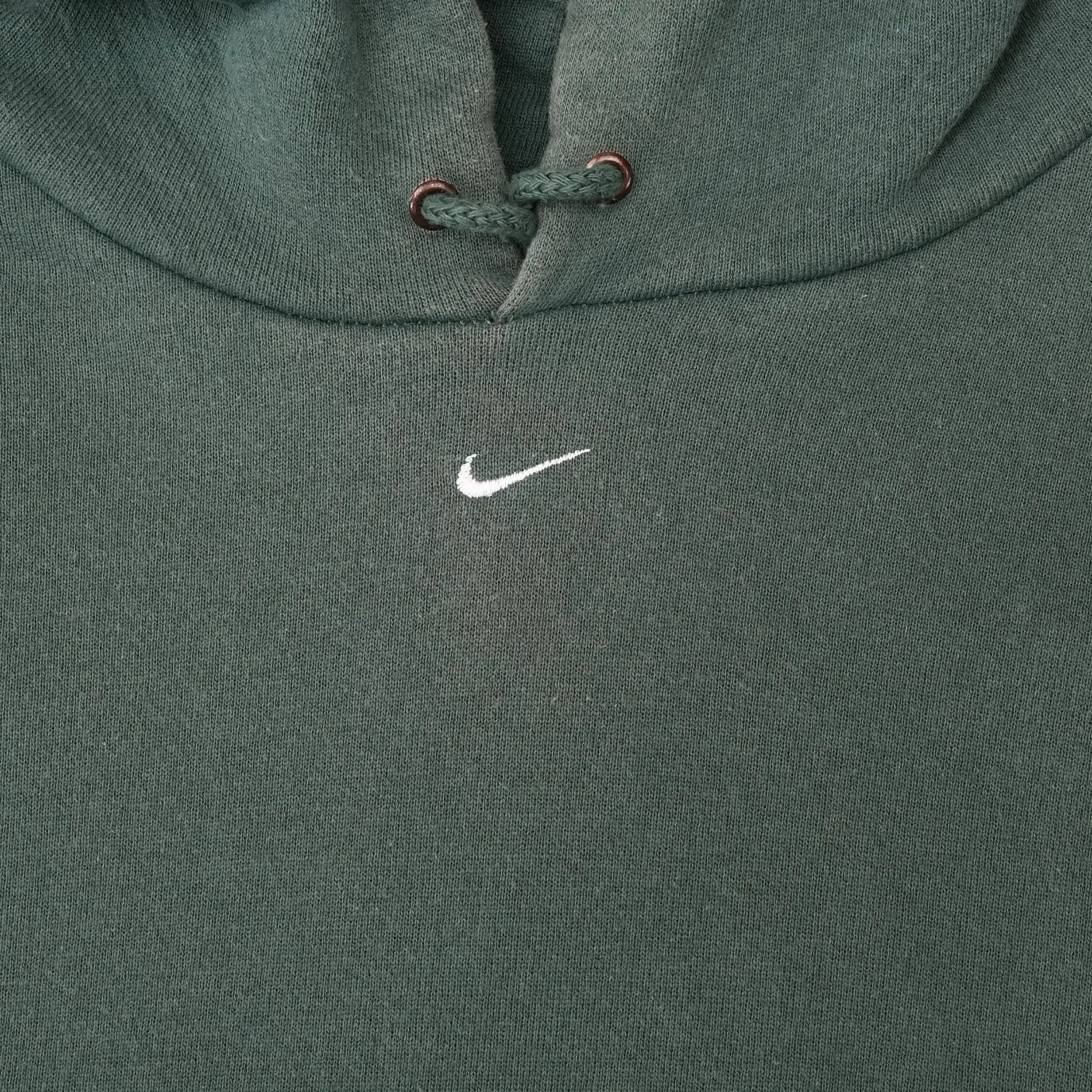 Close-up of small white Nike Swoosh embroidered at the center chest of green hoodie