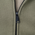 Close-up of black Carhartt zipper pull and olive green hoodie fabric