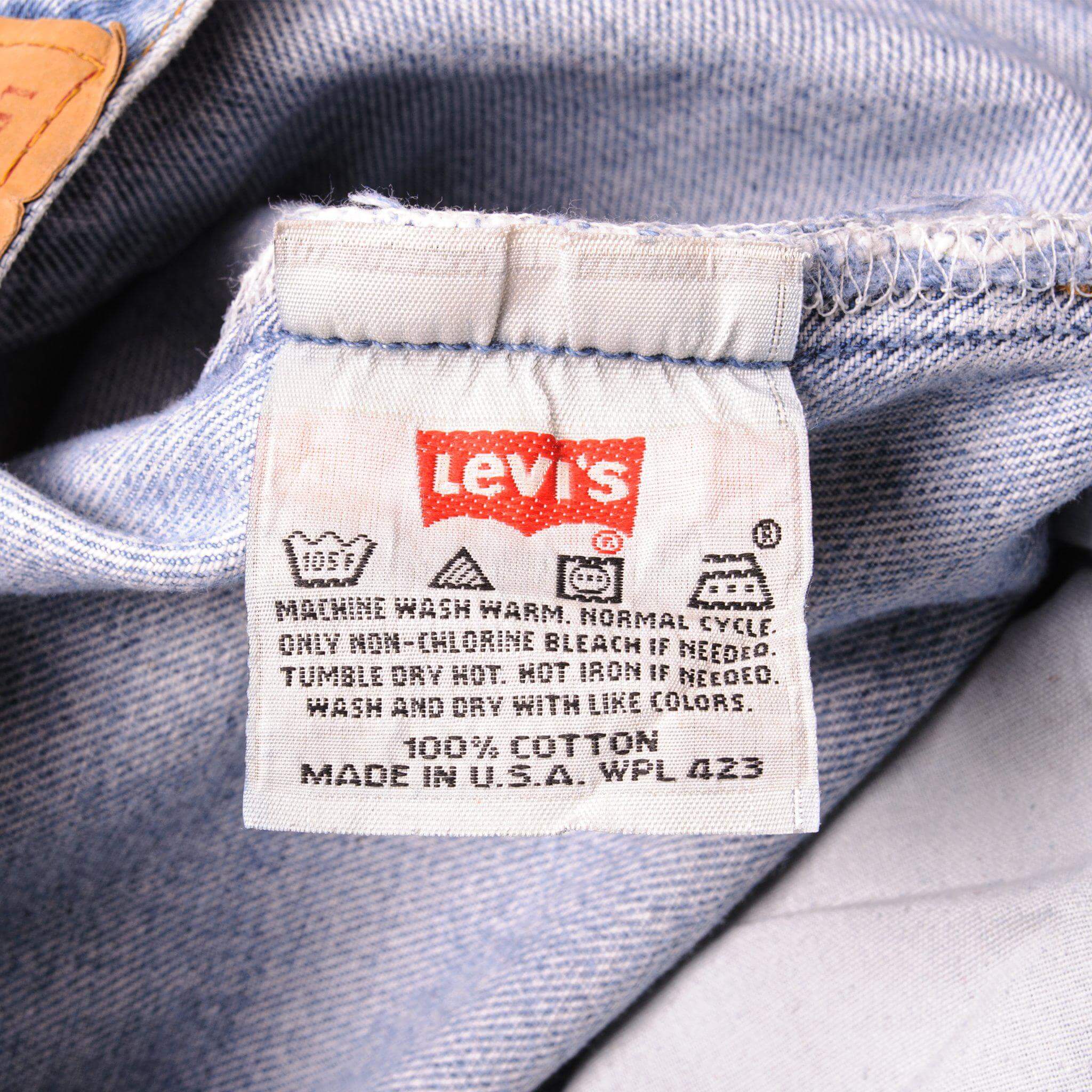 Beautiful Indigo Levis 501 Jeans 1990s Made in USA with a light blue wash and some nice light whiskers.  Size on Tag 28X30  ACTUAL SIZE 26X29  Back Button #553