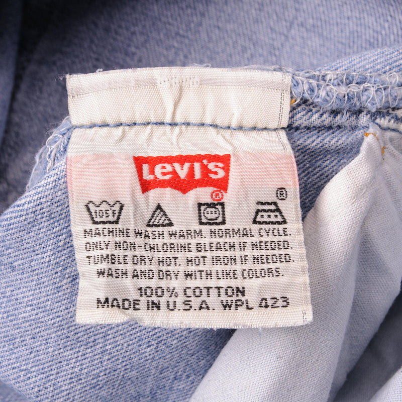 Beautiful Indigo Levis 501 Jeans 1990s Made in USA with a light blue wash.  Size on Tag 31X30  ACTUAL SIZE 31X29  Back Button #553