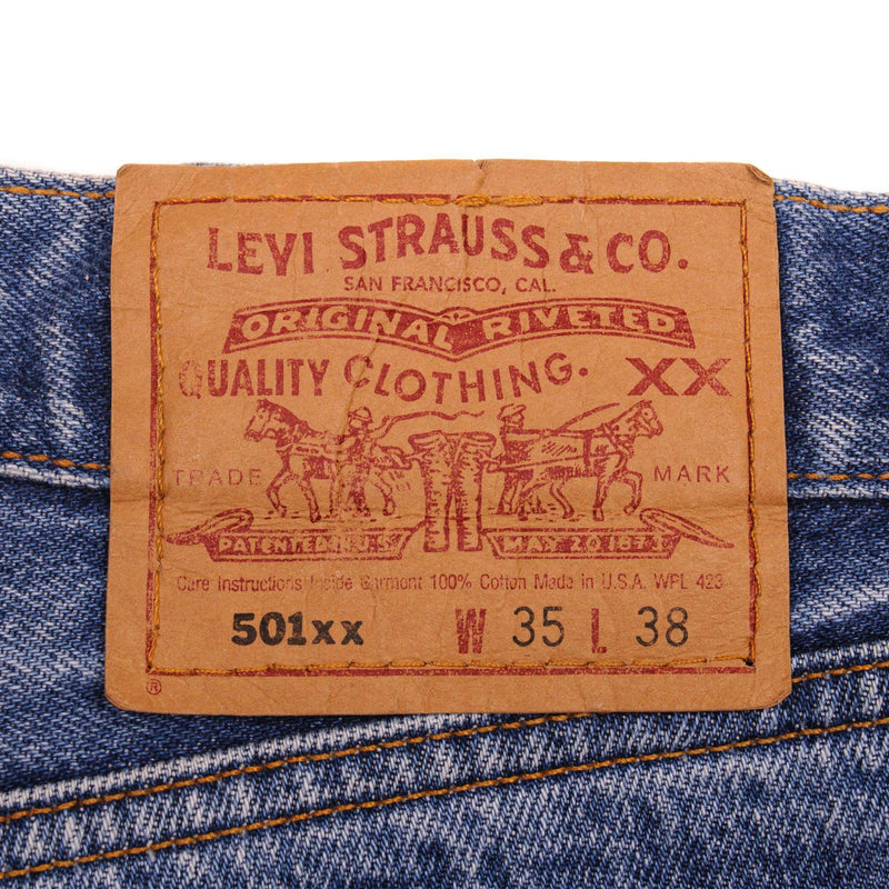 Beautiful Indigo Levis 501 Jeans 1990s Made in USA with a medium blue wash, a nice contrast of light and medium blue and some strong whiskers.  Size on Tag 35X38  ACTUAL SIZE 34X34  Back Button #524